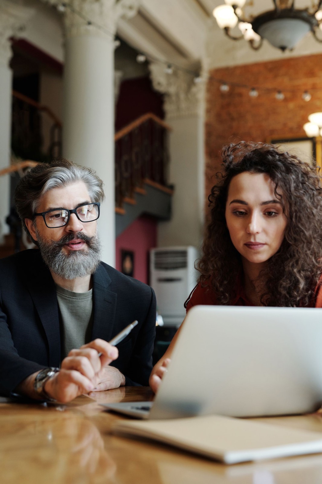 A mentor talking through a plan with a client over a laptop